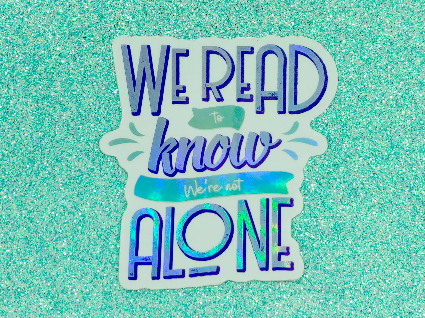 We read to know we're not alone quote holographic bookish vinyl sticker